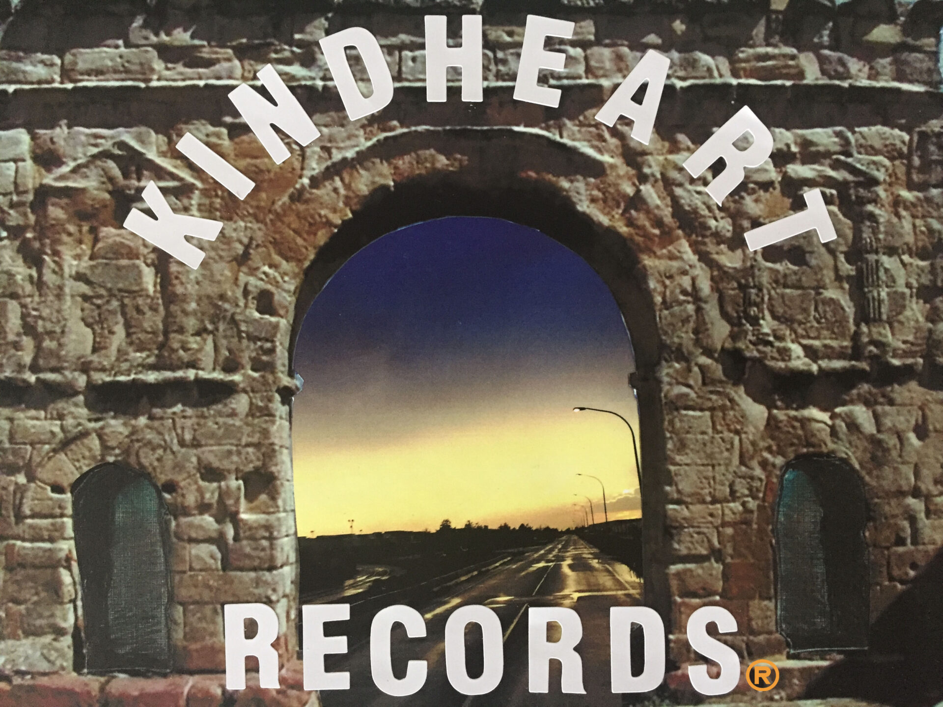 A brick arch with the words " kindheart records " written in it.